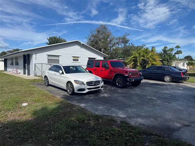 a car parked in front of white house
