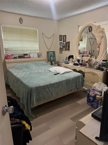 a bedroom with bed and a mirror