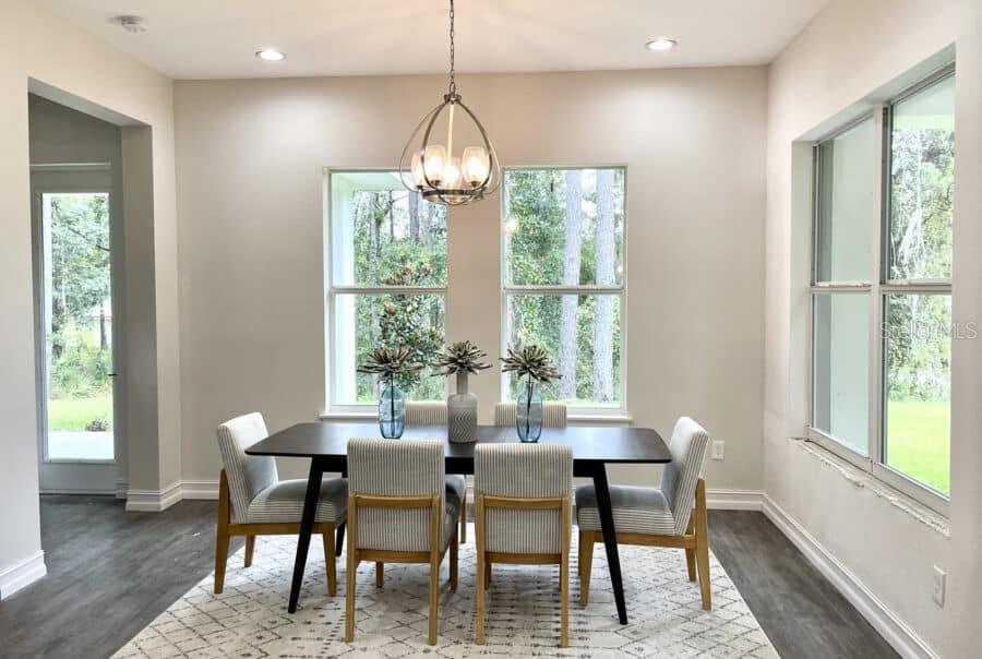 1955 Northwest 79th Loop Ocala, FL 34475 - Photo 5 of 9 a dining room with furniture a chandelier and wooden floor