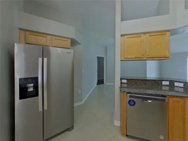 a kitchen with a refrigerator and cabinets