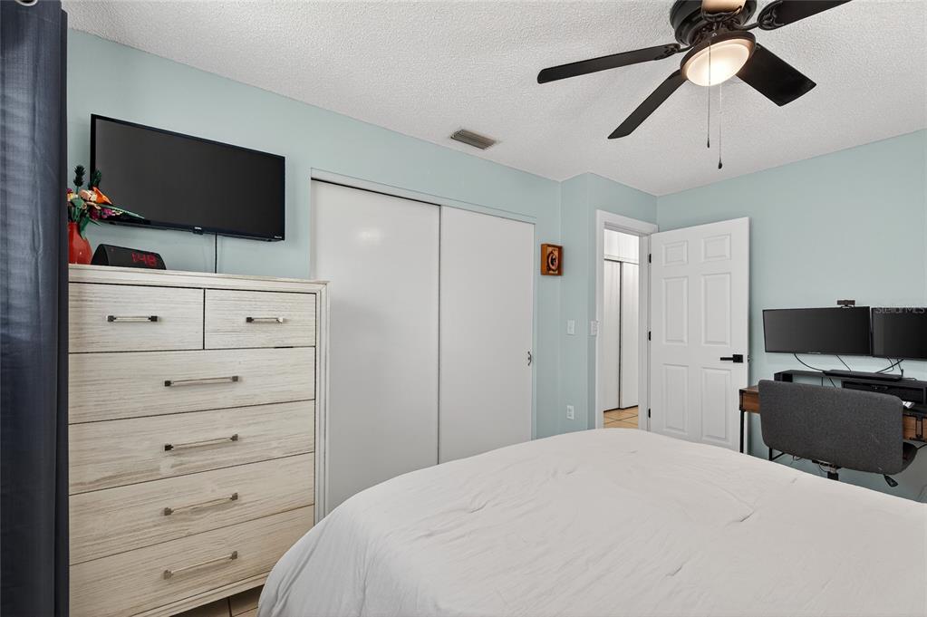 532 Center Road Venice, FL 34285 - Photo 32 of 68 a bedroom with a bed and flat screen tv