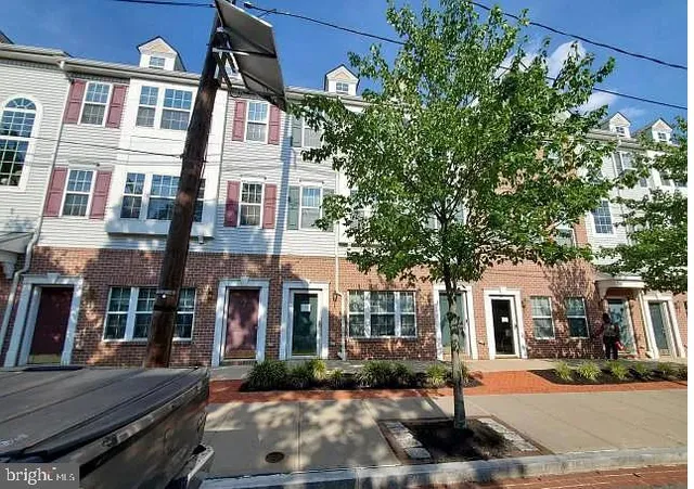 a view of a brick building next to a yard