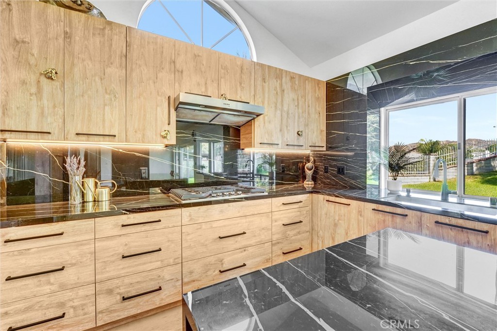 22411 Holly Court Saugus, CA 91390 - Photo 11 of 42 a kitchen with granite countertop white cabinets and white appliances