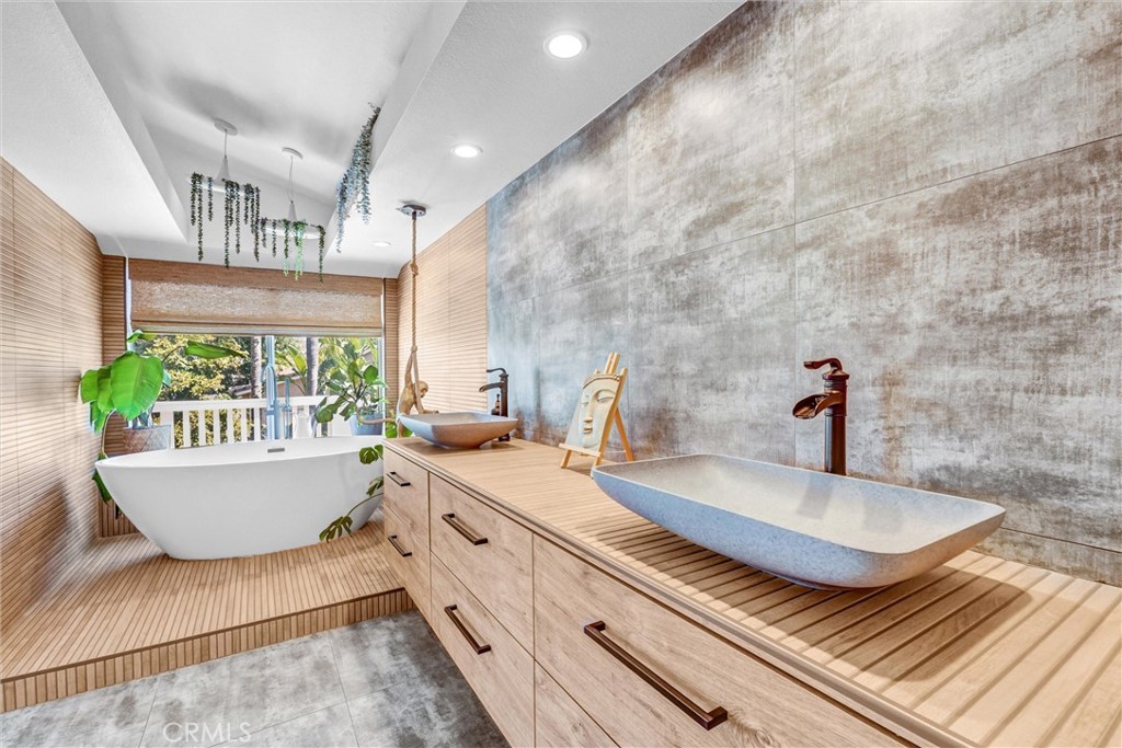 22411 Holly Court Saugus, CA 91390 - Photo 21 of 42 a bathroom with a granite countertop sink and a large mirror