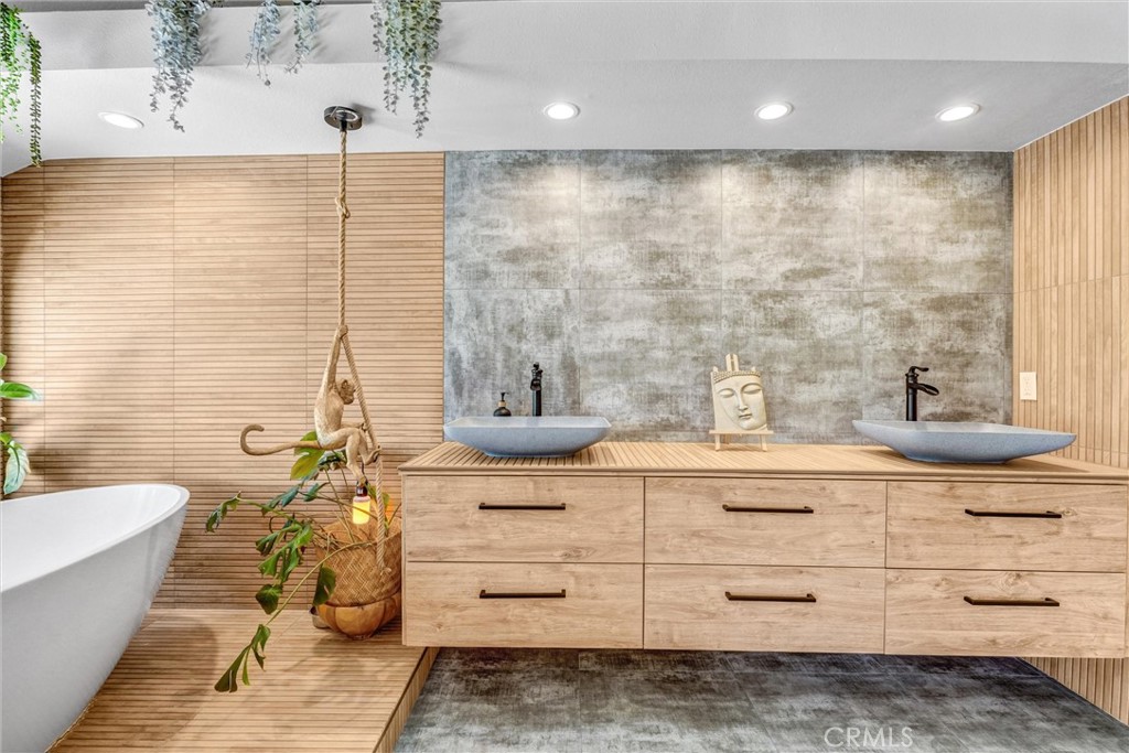 22411 Holly Court Saugus, CA 91390 - Photo 25 of 42 a bathroom with a double vanity sink a mirror and a bathtub