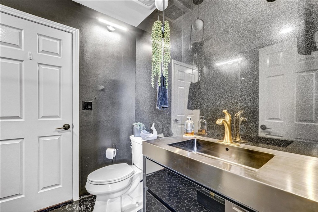 22411 Holly Court Saugus, CA 91390 - Photo 9 of 42 a bathroom with a toilet sink and mirror