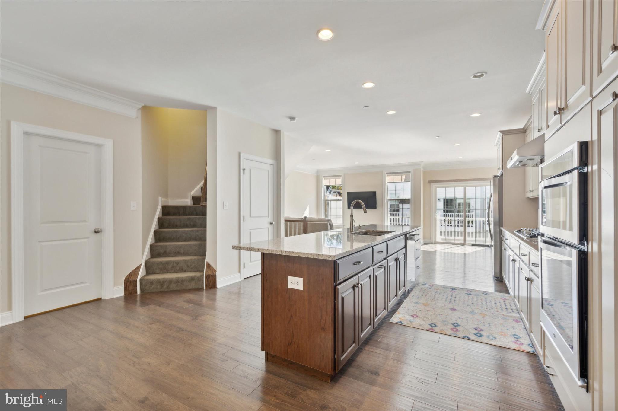 213 Avian Alley Springfield, PA 19064 - Photo 13 of 38 a kitchen with counter top space wooden floor and stainless steel appliances