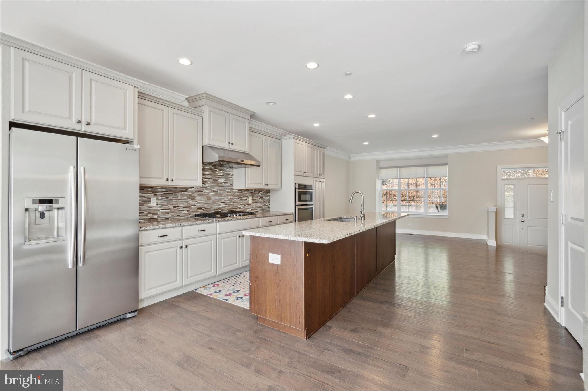 213 Avian Alley Springfield, PA 19064 - Photo 15 of 38 a large kitchen with stainless steel appliances granite countertop a large counter top a stove a refrigerator and white cabinets