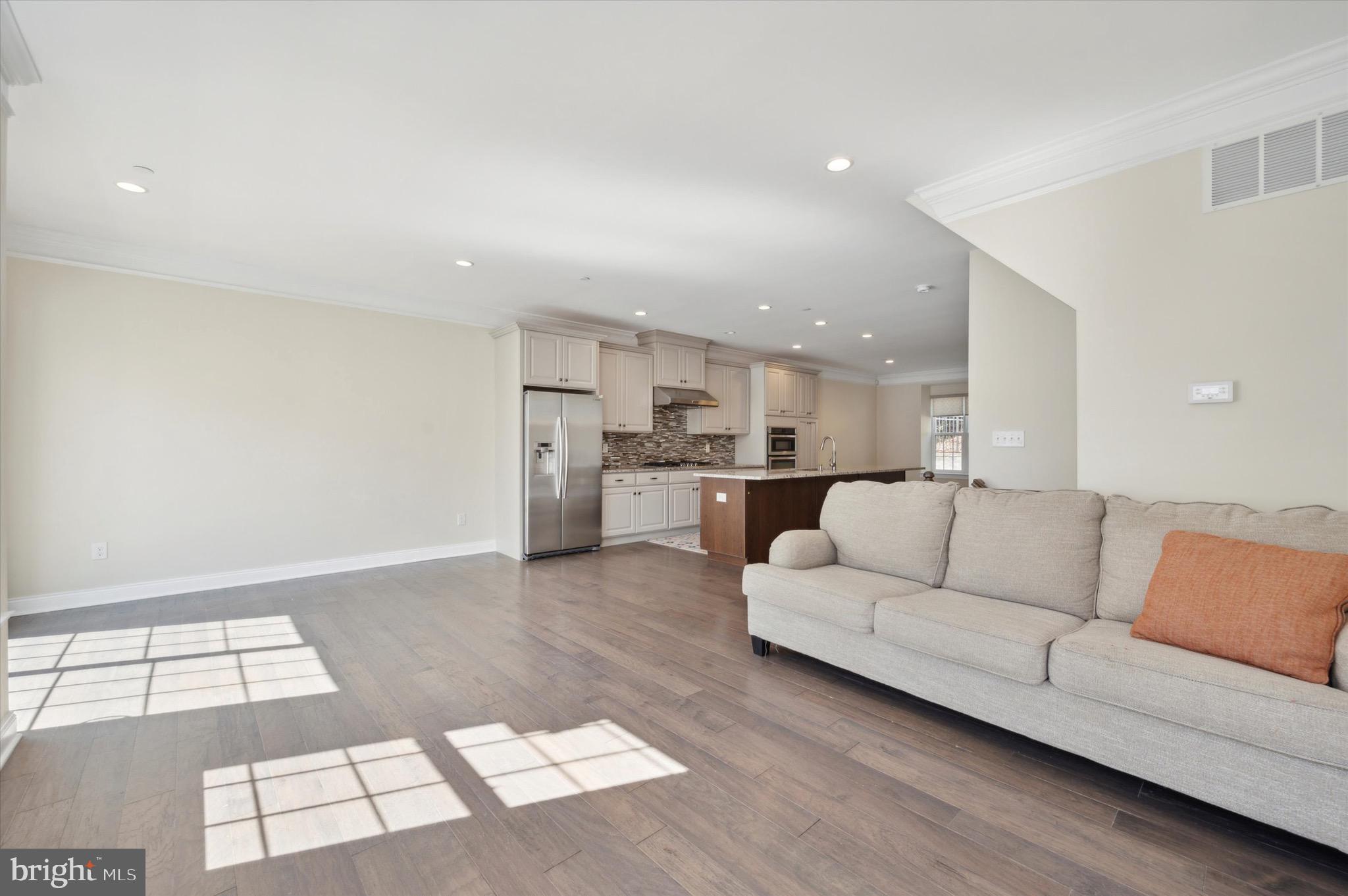213 Avian Alley Springfield, PA 19064 - Photo 18 of 38 a view of kitchen with kitchen island white cabinets and black stainless steel appliances