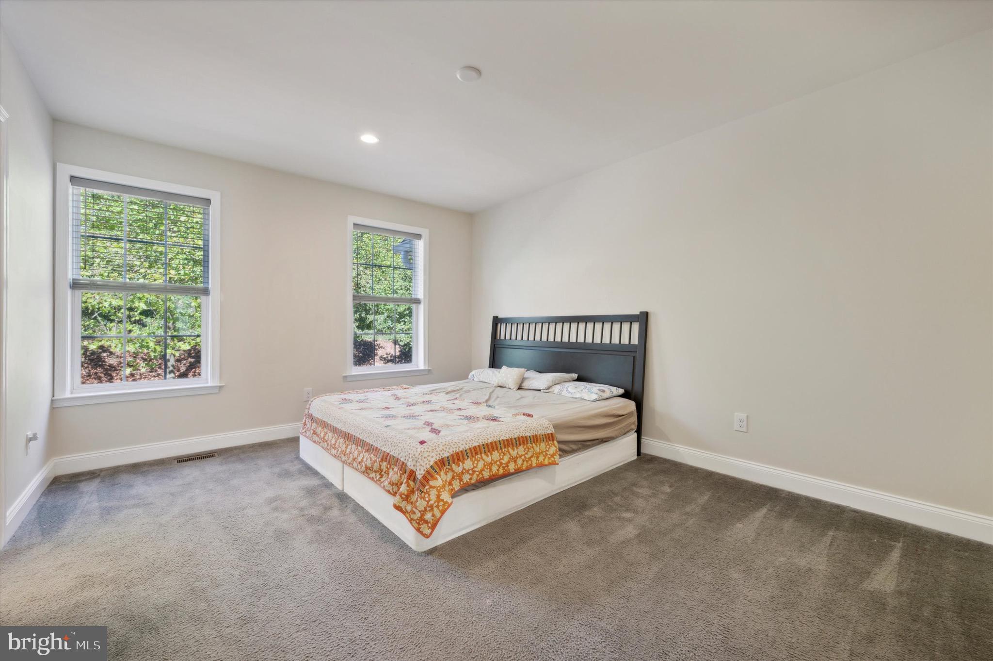 213 Avian Alley Springfield, PA 19064 - Photo 22 of 38 a spacious bedroom with a bed and a window