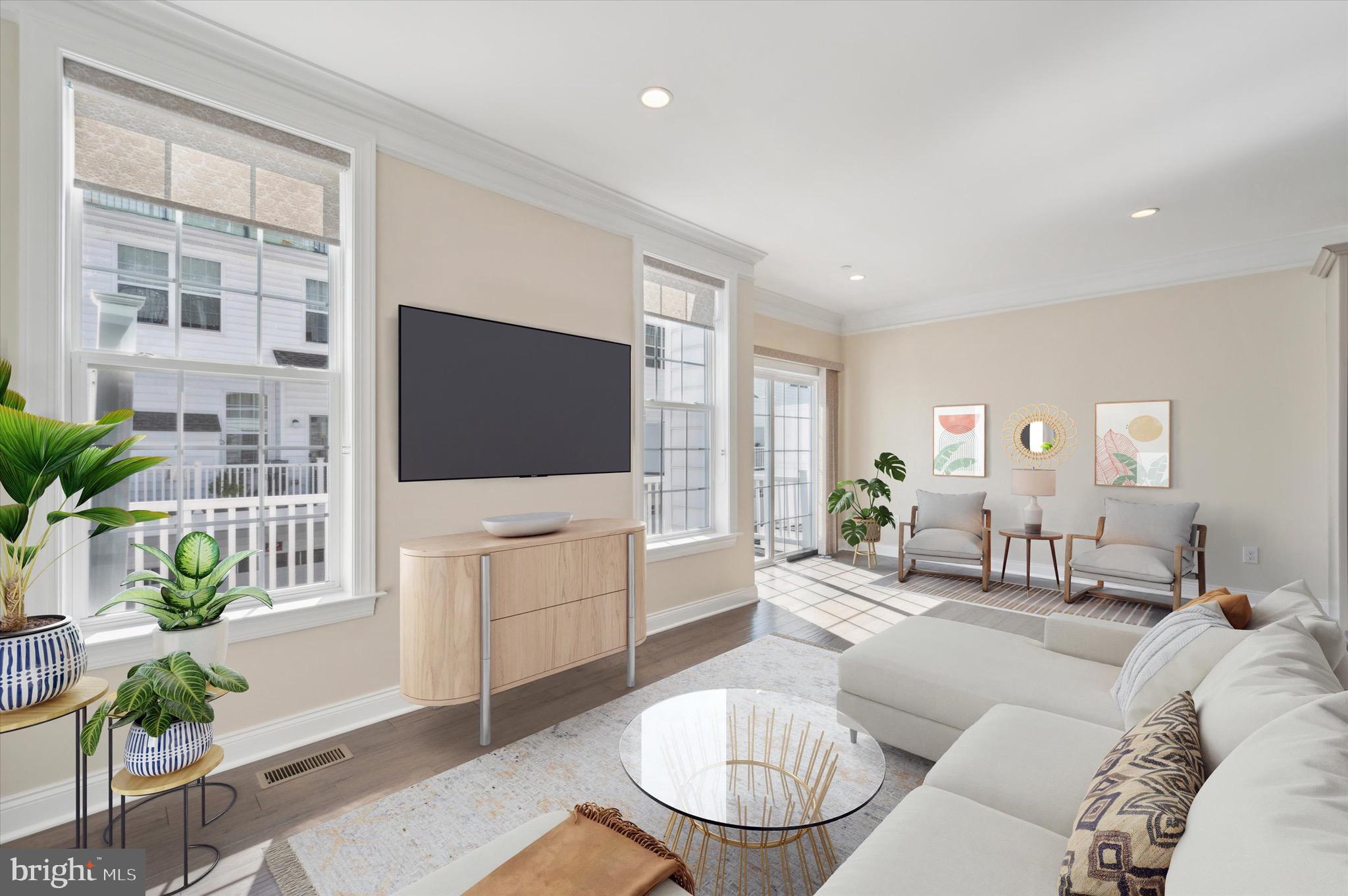213 Avian Alley Springfield, PA 19064 - Photo 4 of 38 a living room with furniture a flat screen tv and a floor to ceiling window