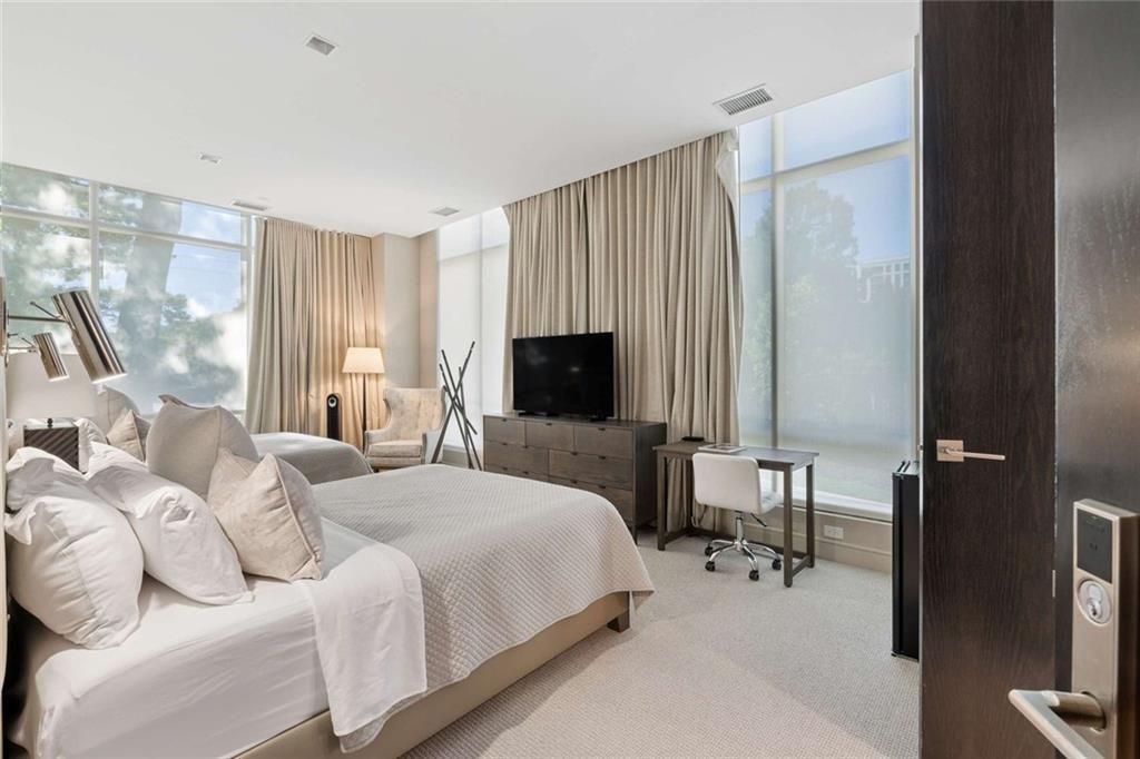 2520 Peachtree Road, Unit 603 Atlanta, GA 30305 - Photo 60 of 91 a bedroom with a bed and a flat screen tv
