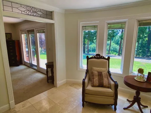 a view of staircase with railing and a chandelier