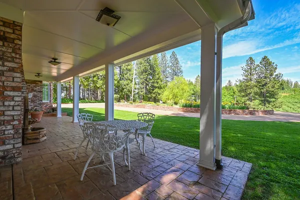 a view of a house with a yard porch and sitting area