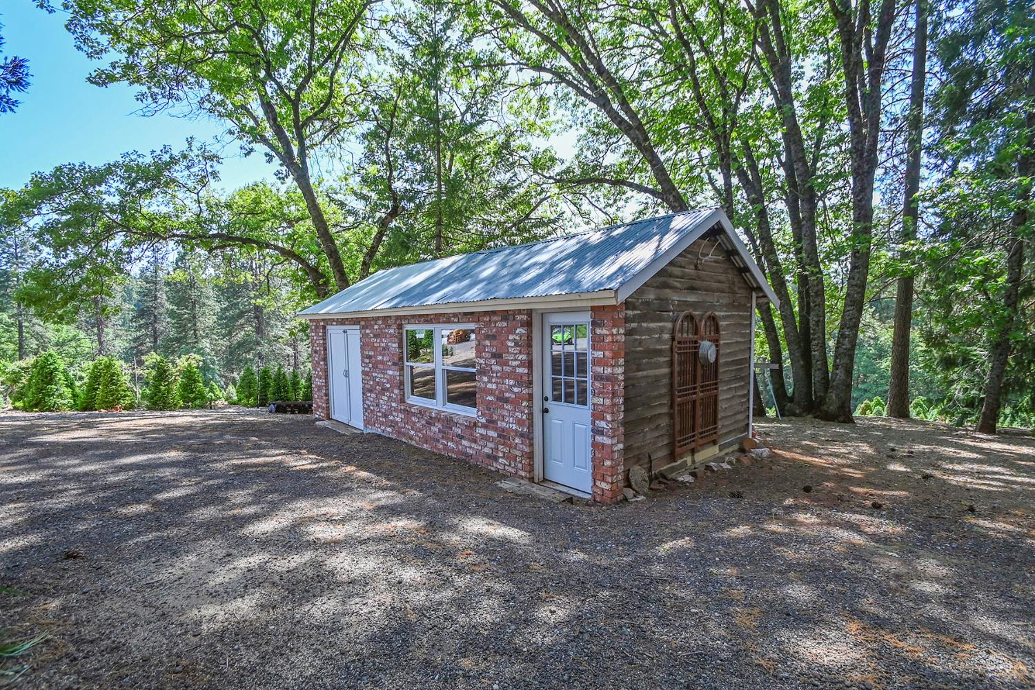 2640 Sky Ranch Lane Camino, CA 95709 - Photo 39 of 62 a view of a wooden house with large trees and wooden fence