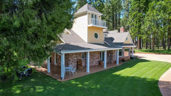a front view of house with yard and green space
