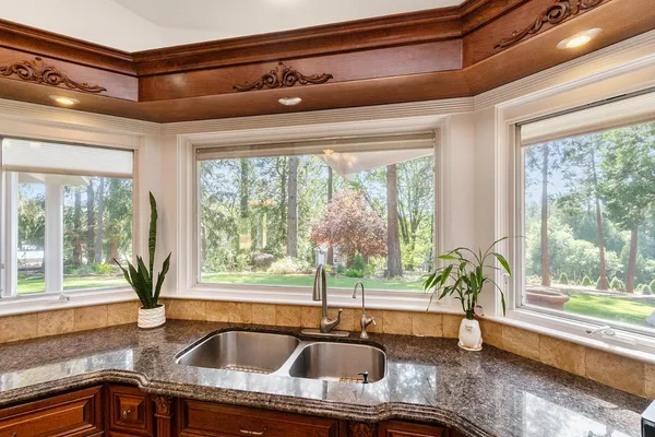 a kitchen with a sink and large window