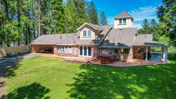 a front view of house with yard and outdoor seating