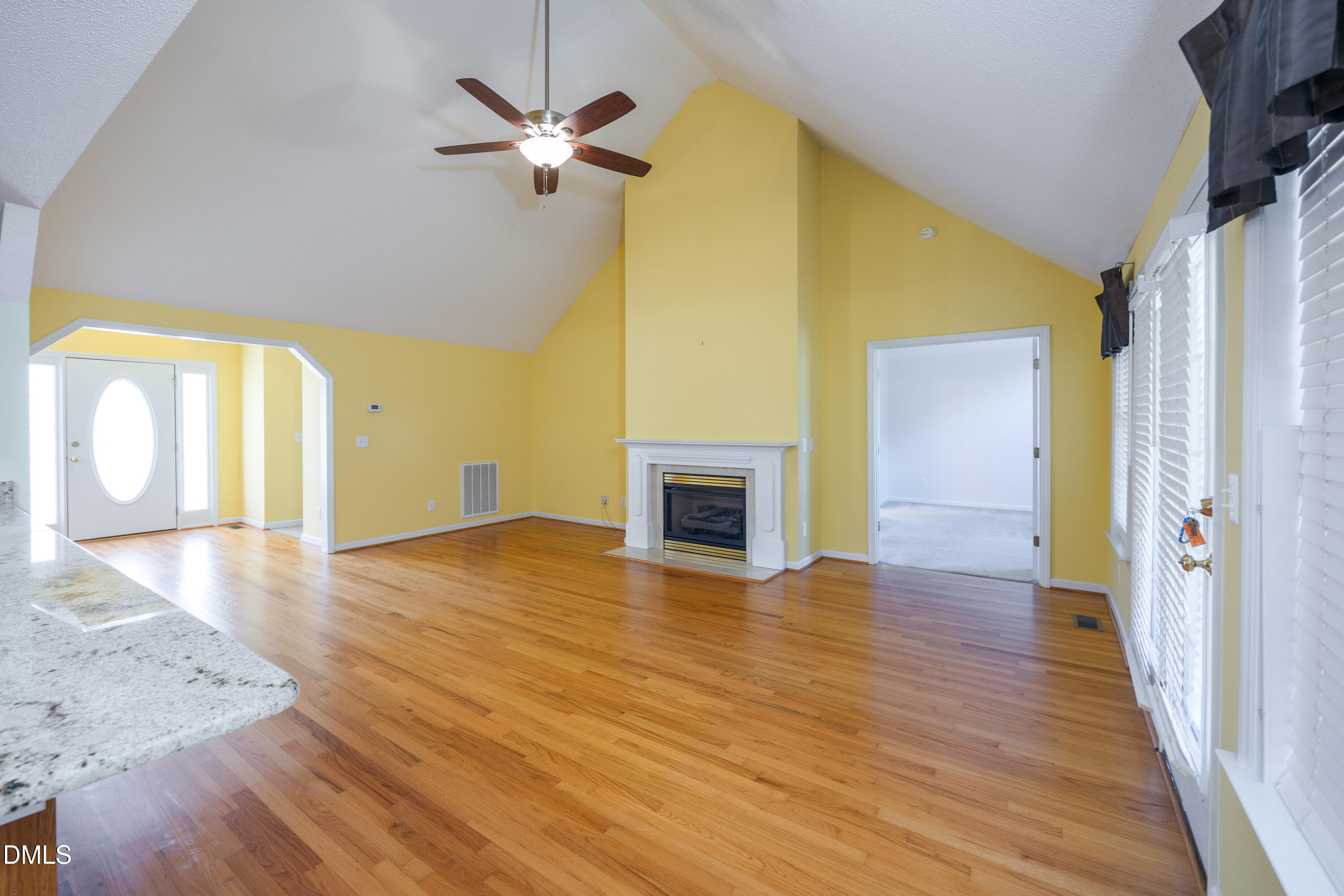 120 Line Drive Raleigh, NC 27603 - Photo 13 of 36 wooden floor in an empty room with a fireplace and a window