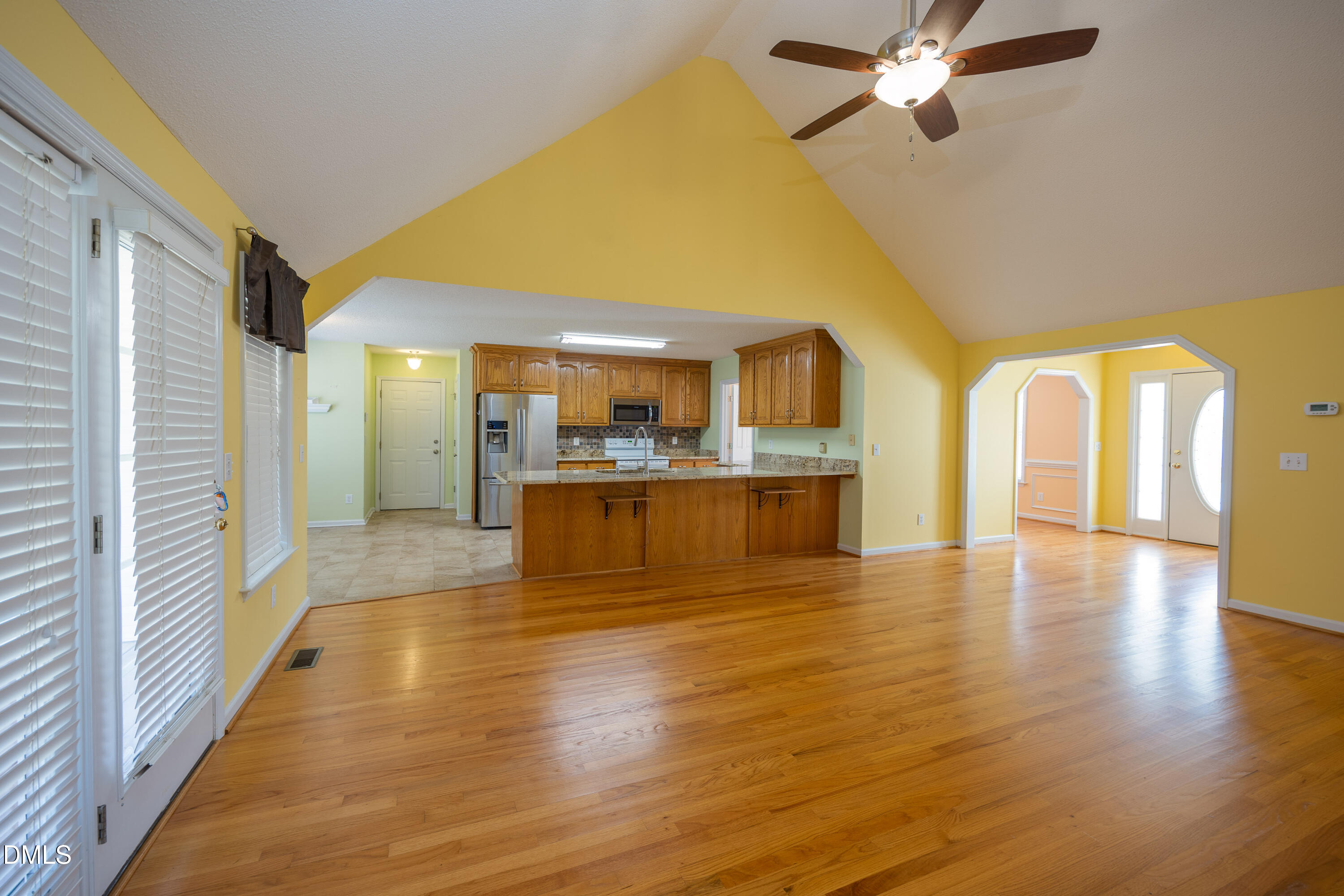 120 Line Drive Raleigh, NC 27603 - Photo 15 of 36 a view of a living room with kitchen view and wooden floor