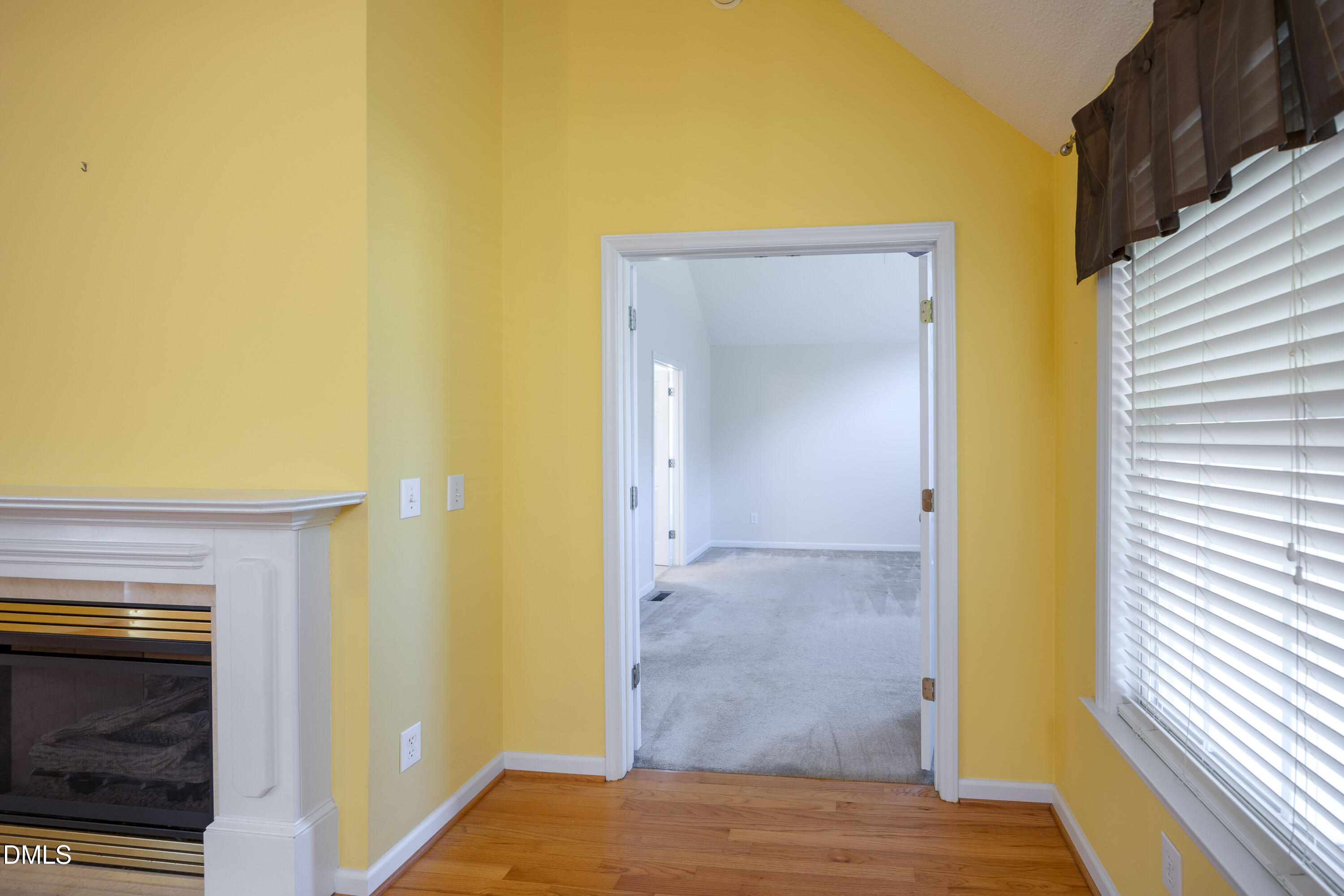 120 Line Drive Raleigh, NC 27603 - Photo 16 of 36 a view of a hallway with wooden floor and a fireplace