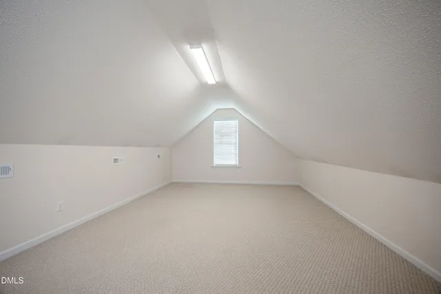 an empty room with a empty space and windows