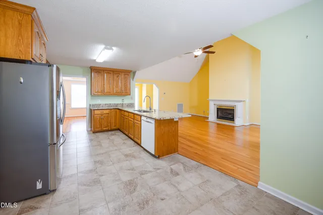 a view of a kitchen with a sink and a refrigerator