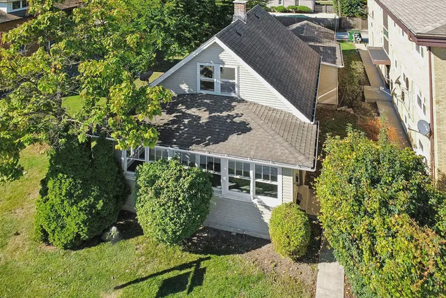 a view of a house with brick walls and flower plants