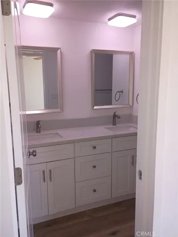 a bathroom with a granite countertop sink double and mirror