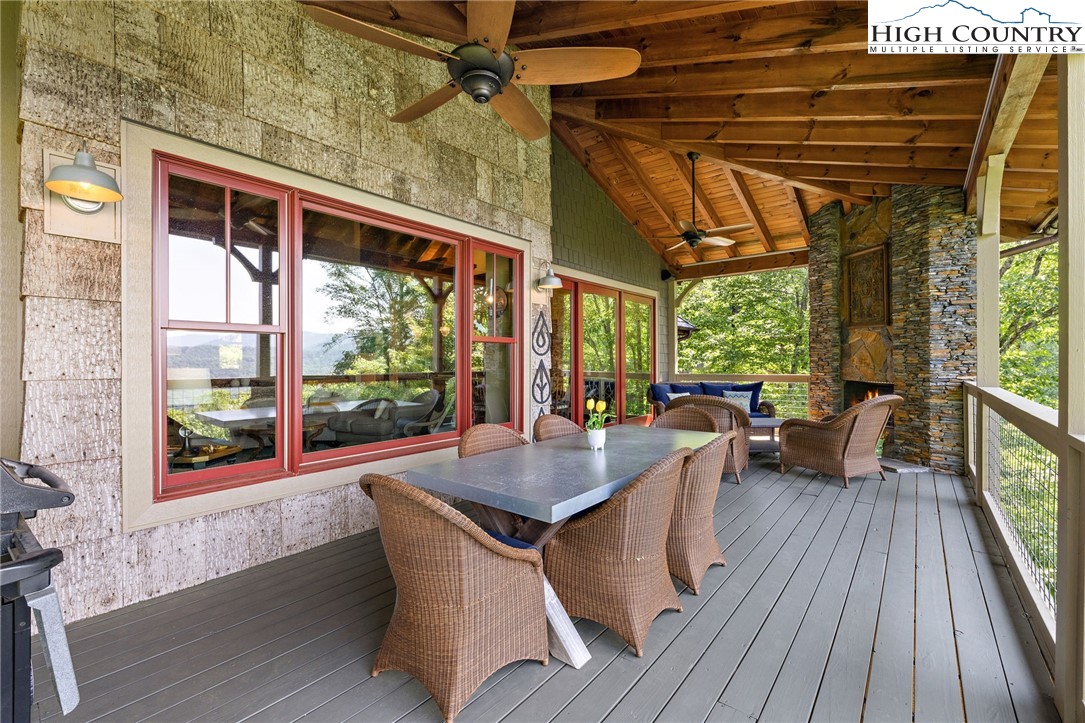 177 Stonecrop Lane Boone, NC 28607 - Photo 8 of 49 a dining room with wooden floor outdoor seating and windows