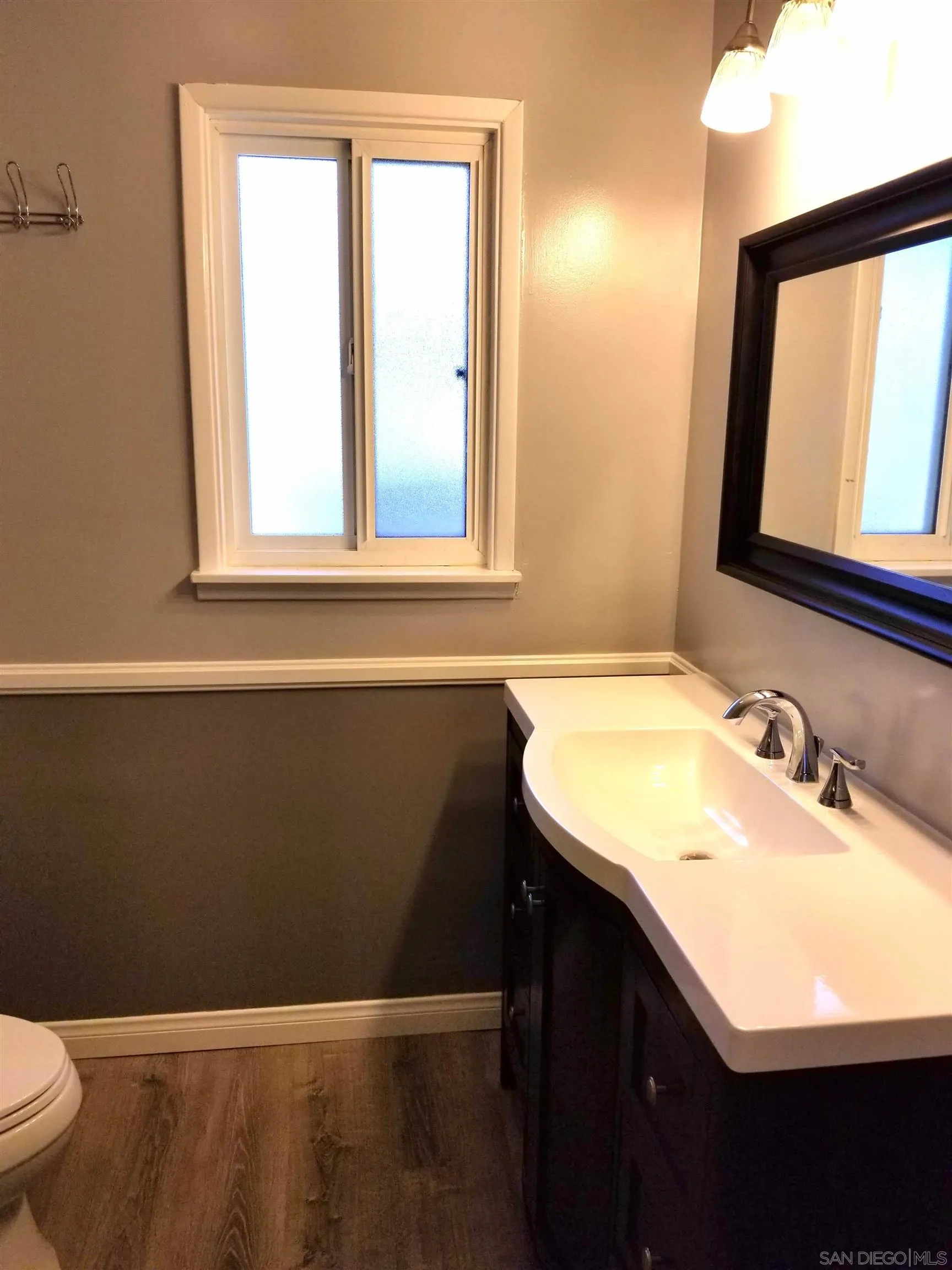 5051 63rd Street San Diego, CA 92115 - Photo 11 of 28 a bathroom with a sink a vanity and a toilet