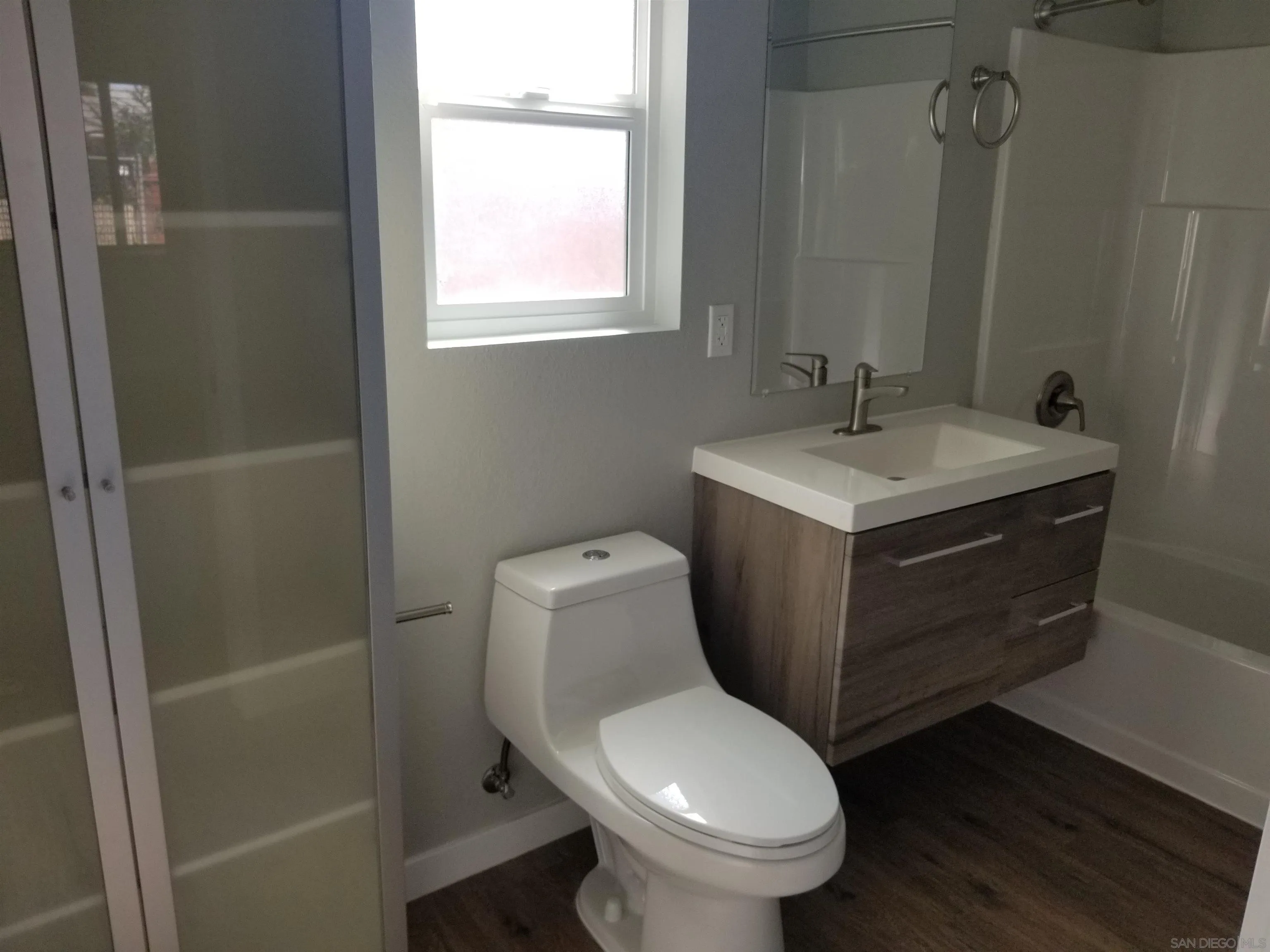 5051 63rd Street San Diego, CA 92115 - Photo 20 of 28 a bathroom with a toilet sink and mirror