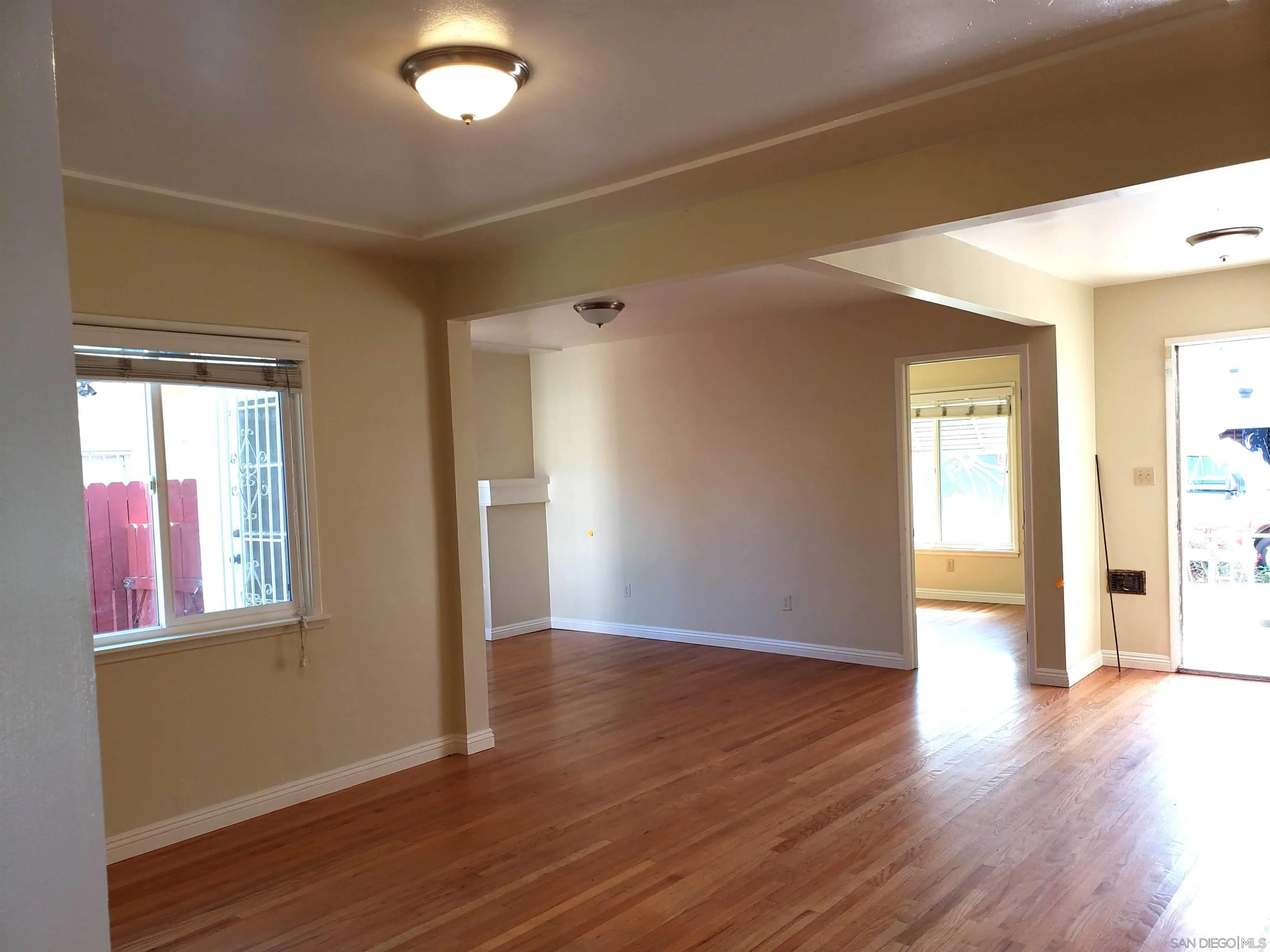 5051 63rd Street San Diego, CA 92115 - Photo 2 of 28 a view of an empty room with wooden floor and a window
