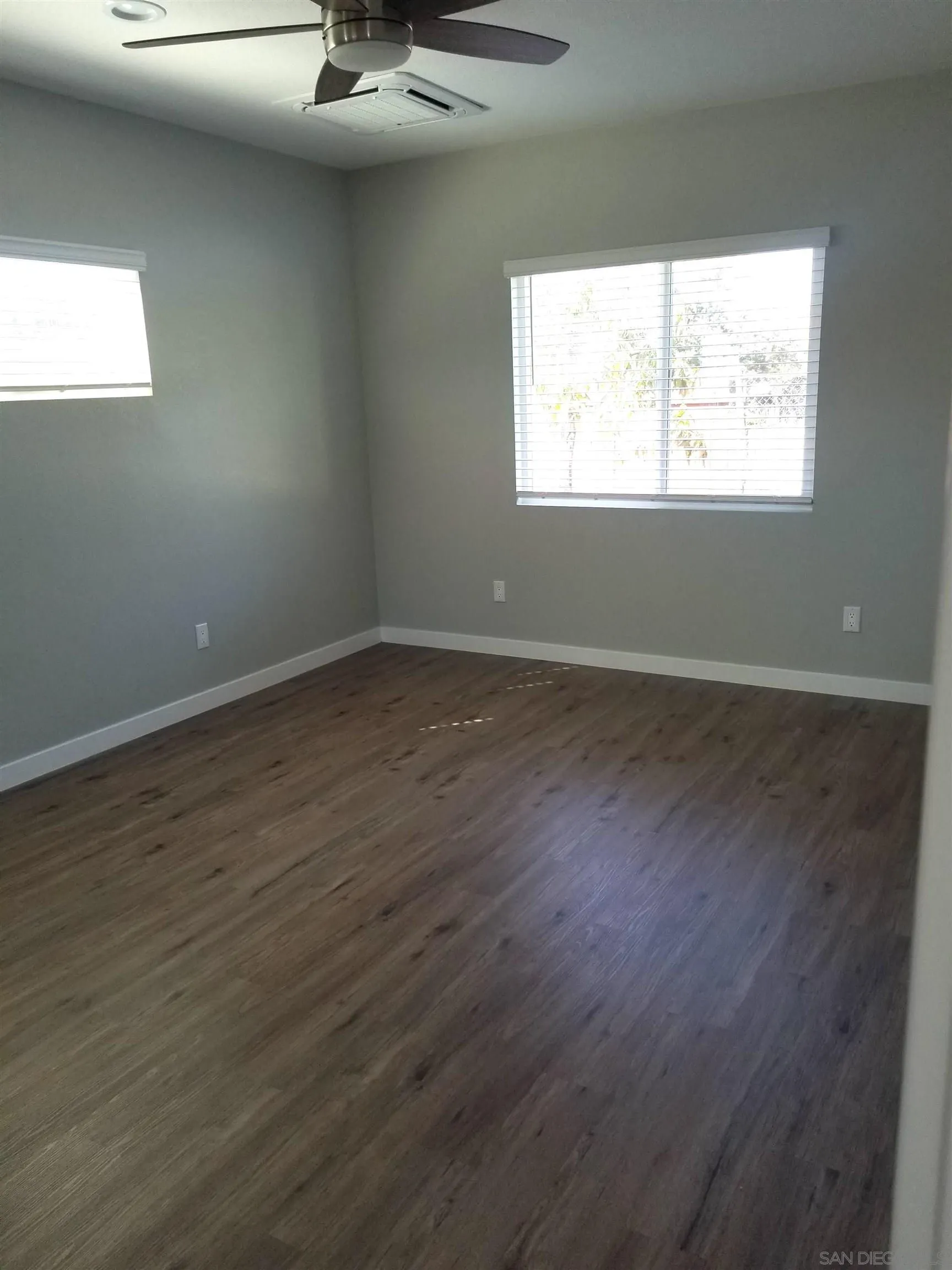 5051 63rd Street San Diego, CA 92115 - Photo 22 of 28 an empty room with wooden floor and windows