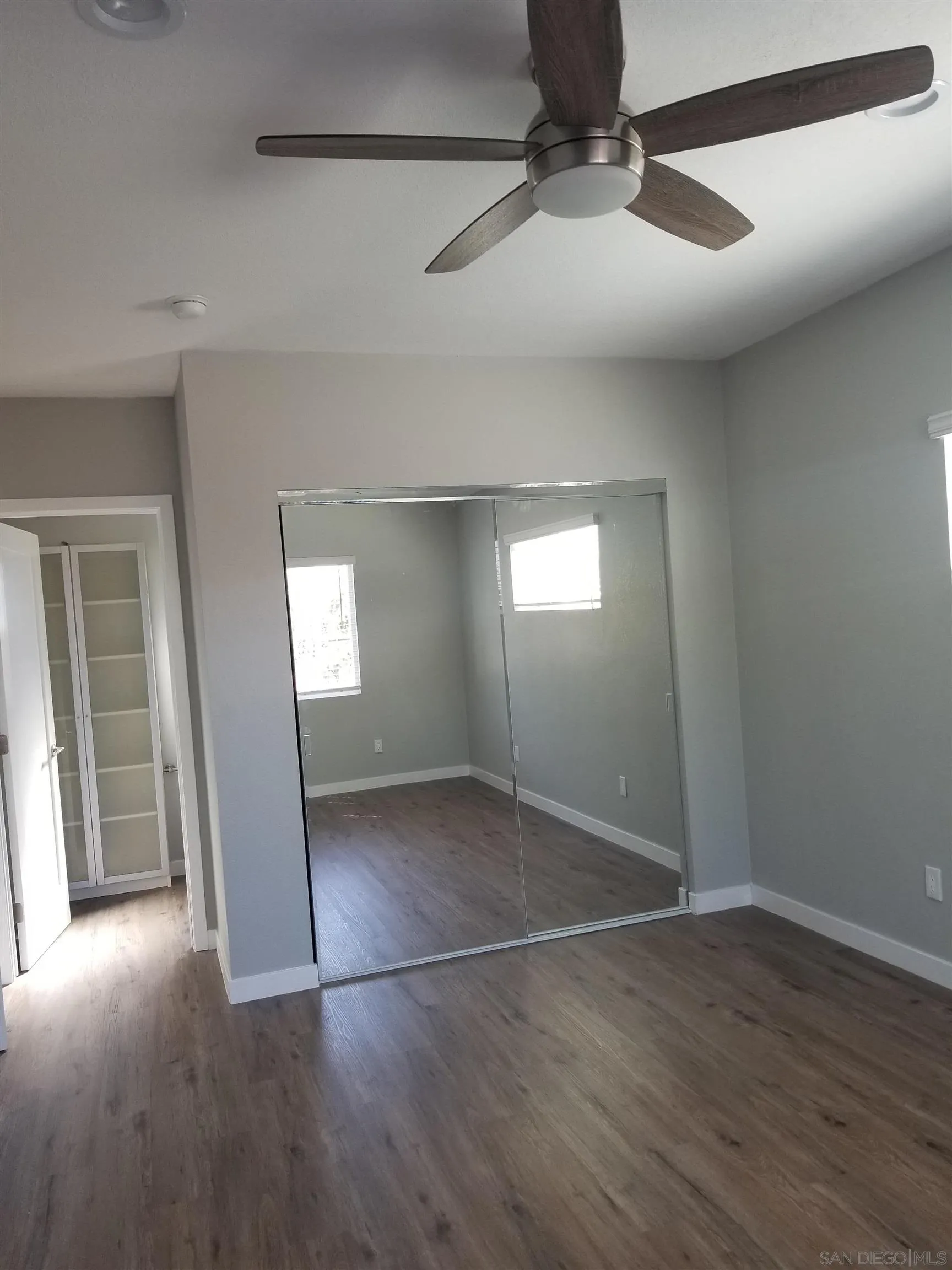 5051 63rd Street San Diego, CA 92115 - Photo 23 of 28 an empty room with wooden floor and windows