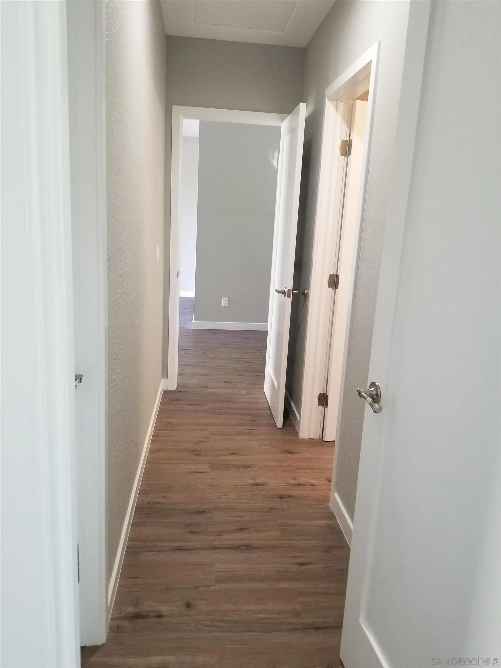 5051 63rd Street San Diego, CA 92115 - Photo 25 of 28 a view of a hallway with wooden floor and staircase