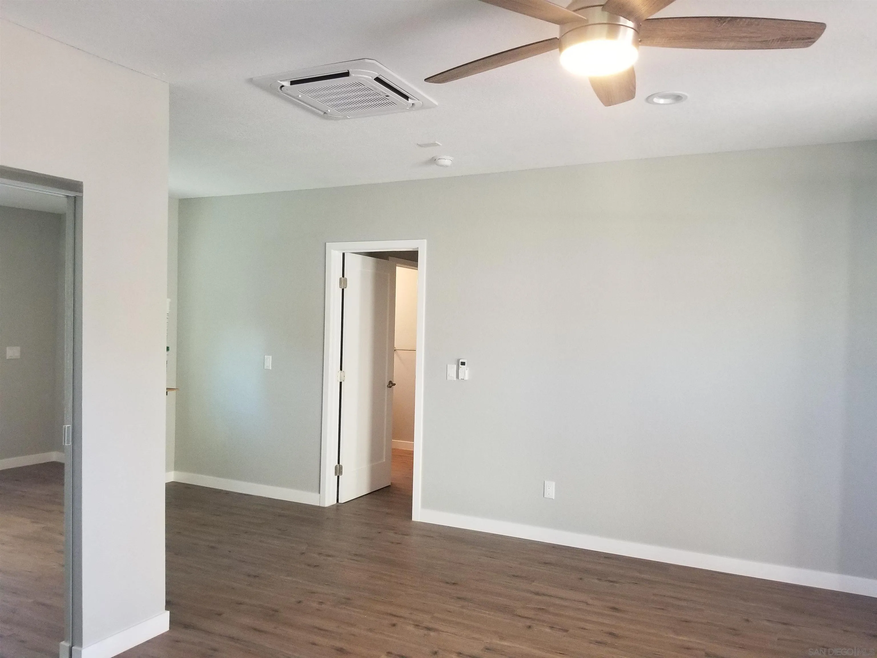5051 63rd Street San Diego, CA 92115 - Photo 26 of 28 a view of an empty room with wooden floor