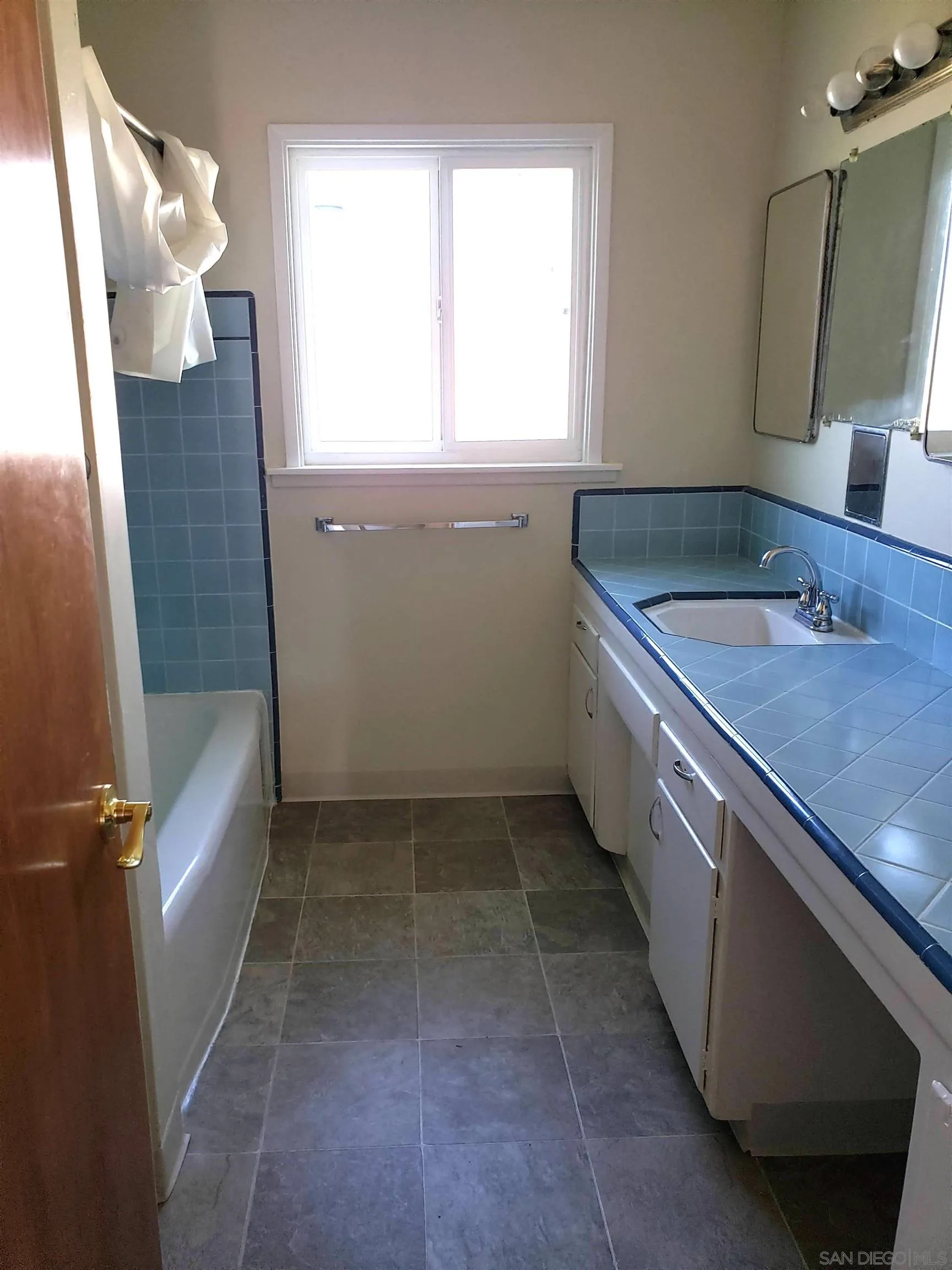 5051 63rd Street San Diego, CA 92115 - Photo 9 of 28 a bathroom with a sink a toilet and a mirror
