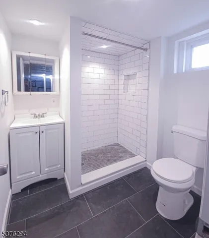a bathroom with a shower a toilet and sink