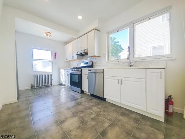a view of a kitchen with sink cabinets and outdoor space