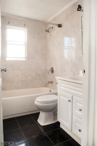 a bathroom with a toilet a sink and a bathtub