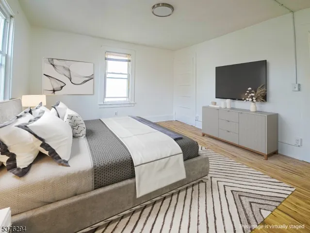 a bedroom with a bed and flat screen tv