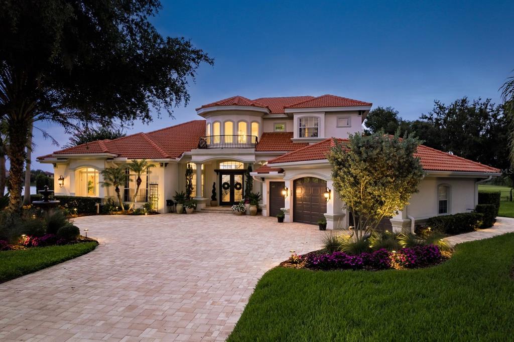 10342 Altrara Way Trinity, FL 34655 - Photo 1 of 1 a front view of a house with a garden