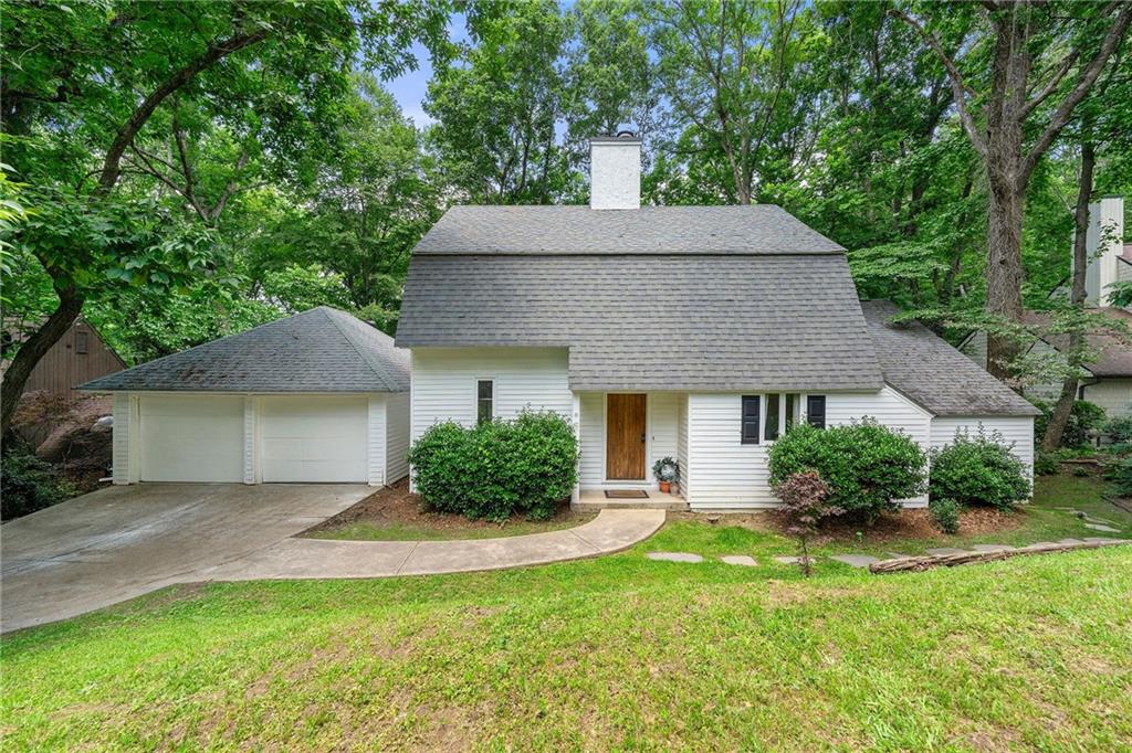 4018 Dunbarton Way Roswell, GA 30075 - Photo 1 of 1 a front view of a house with a yard and garage