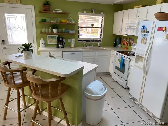 a kitchen with a sink cabinets and window