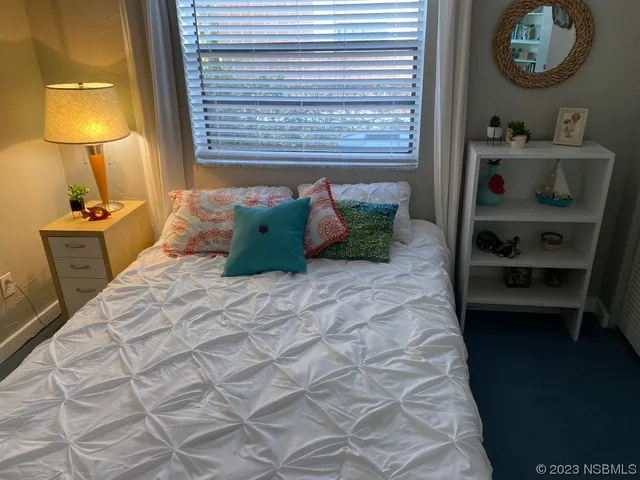 a bedroom with a bed and a dresser