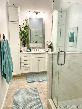 a bathroom with a double vanity sink and mirror