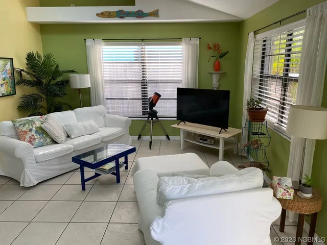 a living room with furniture and a flat screen tv