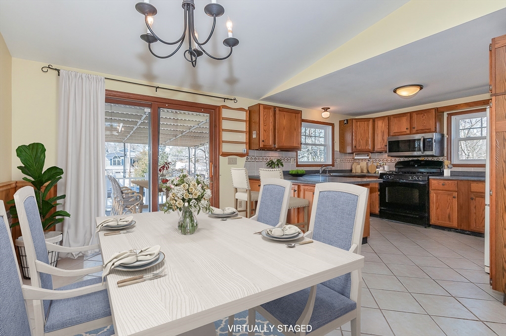 7 Roosevelt Street Wareham, MA 02571 - Photo 11 of 29 a kitchen with granite countertop a table chairs stove and cabinets