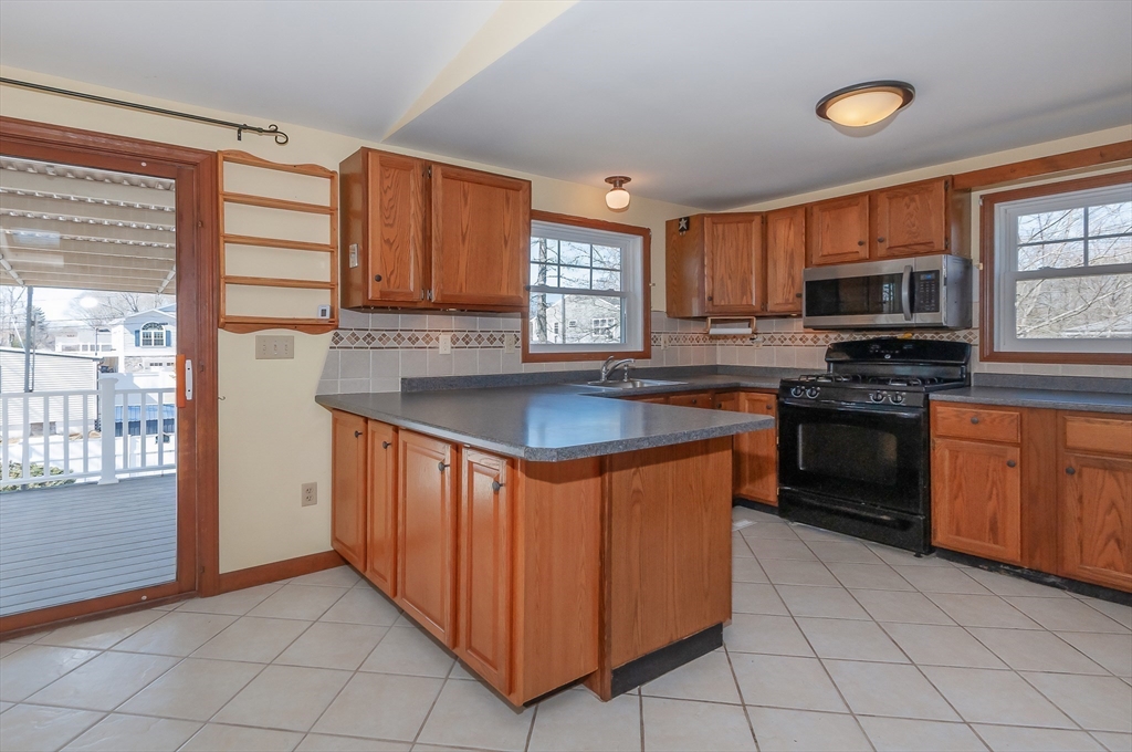 7 Roosevelt Street Wareham, MA 02571 - Photo 12 of 29 a kitchen with stainless steel appliances granite countertop a stove a sink and a refrigerator